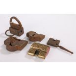 Four various Middle Eastern padlocks, the largest 7.5cm wide, and a Chinese brass padlock, 6cm