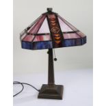 Tiffany style table lamp, in the Art Nouveau taste, with amethyst and leaded shade above a square