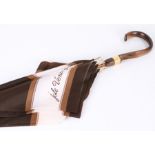 Jole Veneziani, in brown and white fabric by Diana Marino, wooden handle with brass buckle collar,