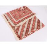 Ladies blanket scarf, printed in pinks and browns on a white ground, with parallel lines within a