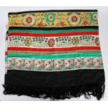 Ladies silk scarf, printed with colourful flowers with red, green and black stripes, black tassled