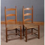 Pair of 19th Century Shaker chairs, with an arched ladder back above the rush woven seat and
