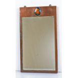 Arts and Crafts style mirror, the rectangular copper frame mounted with a multi-coloured enamel