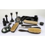 Collection of early 20th Century ebony dressing table items, to include candlesticks, a clock, tray,
