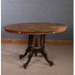 Victorian walnut inlaid loo table, having an oval inlaid snap top, raised on a carved base and