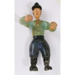 Folk art type carved figure, of a man wearing a bowler hat above the turquoise shirt and arms wide