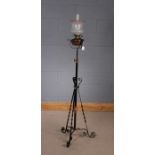 Early 20th Century Art Nouveau wrought iron oil standard lamp, having frosted glass shade with