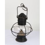 20th Century toleware hanging oil lamp, having pierced chimney above a glass globular body and