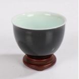 Chinese porcelain wine cup, with black exterior and white interior, four character marks to base, on