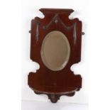 Edwardian mahogany mirrored wall bracket, with drop garland carved motif above an oval bevelled