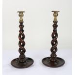 Pair of 20th century oak barley twist candlesticks, with brass candle sconces above open twist