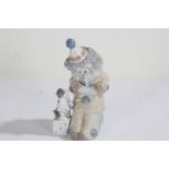 Lladro figure, in the form of a child dressed as a clown with a puppy, 15cm high