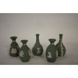 Five Wedgwood green jasperware vases, with classical decoration (5)