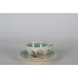 Susie Cooper cup and saucer, the cream and green body decorated with flowers (2)