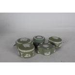 Five Wedgwood green jasperware pots and covers, with classical decoration (5)