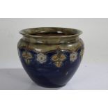 Royal Doulton stoneware jardeniere, decorated with Art Nouveau stylised flowers on a blue ground,
