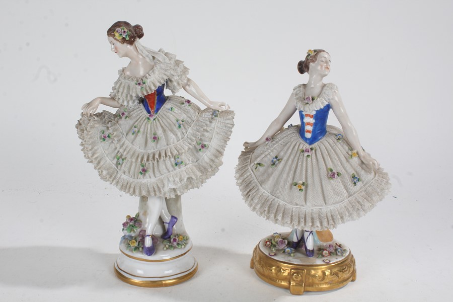 Two Sitzendorf porcelain figures, with of ladies with foliate dresses, crown above S marks to the