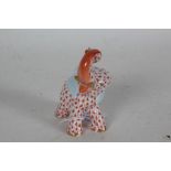 Herend porcelain figure depicting an elephant with trunk raised, with red scale decoration,