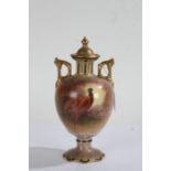 Crown Devon hand painted vase and cover, having gilded lift up lid, the ovoid body painted with