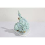 Herend porcelain group of two rabbits, in the green fishnet pattern, on a shaped white glazed