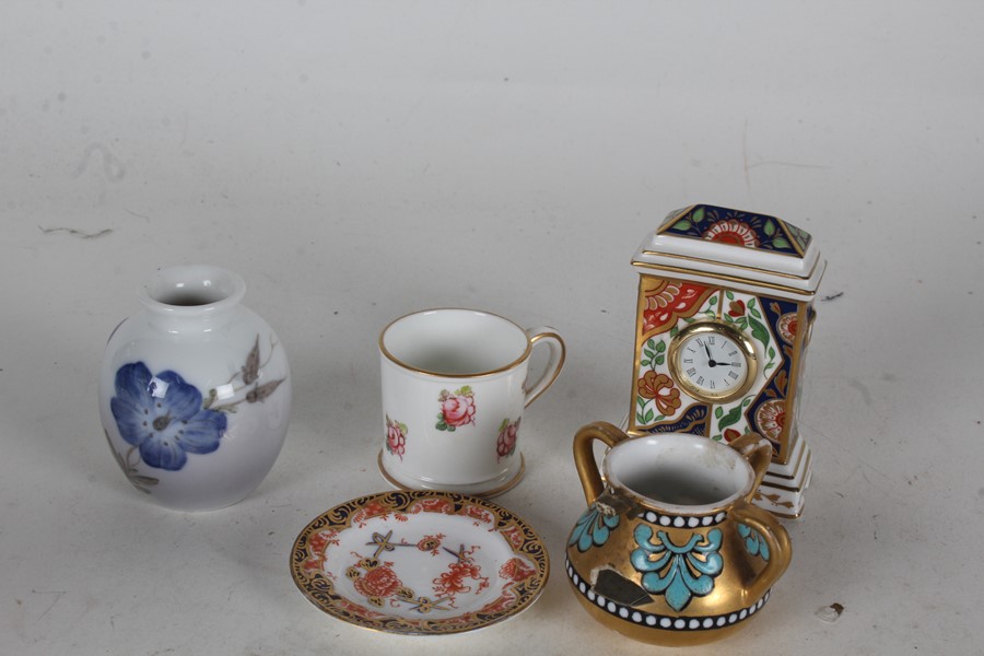 Three Royal Crown Derby miniature china items, in the form of a timepiece, mug and dish, together