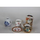 Three Royal Crown Derby miniature china items, in the form of a timepiece, mug and dish, together