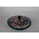 Moorcroft pottery powder bowl and cover, the lid with flowers on a green ground, blue signature to