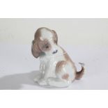 Lladro dog, modelled seated with a butterfly to the tail, 10cm high