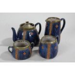 Royal Doulton stoneware tea set, the blue ground with bands of stylised foliate and scroll