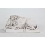 Lion ornament, in a white matt glaze, modelled lying down and raised on a rectangular base, 22cm