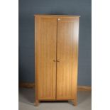 Light oak wardrobe, hinged doors to reveal a single shelf and rail,191cm tall