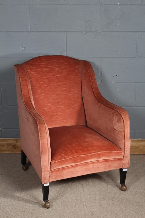 Wing arm chair upholstered in pink fabric, with ebonised feet, 97cm tall