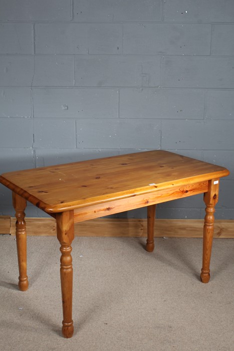 Stripped pine dining table, the rectangular top above four turned legs, 121cm wide, 68cm long and