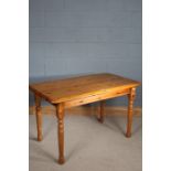 Stripped pine dining table, the rectangular top above four turned legs, 121cm wide, 68cm long and