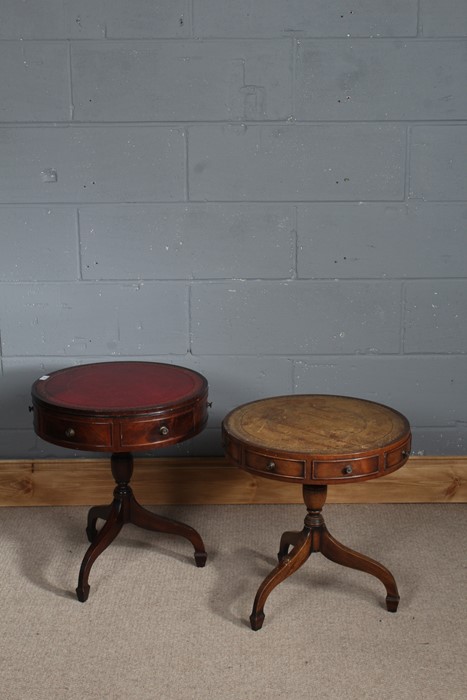 Two drum tables, one of which has a hinged top and faux draws above a turned column the other has