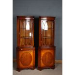 Pair of mahogany effect corner cupboards with glazed doors, above one draw, 182cm tall