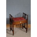 Early 20th Century mahogany piano stool, with upholstered lift up seat, slatted sides and spindled