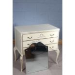 Painted dressing table, the mirror back above the serpentine top and three drawers, raised on
