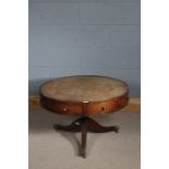 George III style mahogany drum table with four draws, with a leather top above a baluster column,
