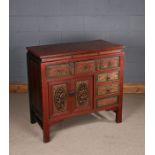 Chinese red painted chest, the rectangular top above five short drawers and a cupboard, the fret