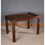 Chinese hardwood and iron topped table, the rectangular iron top above ring turned legs having