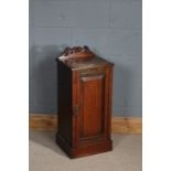 Late Victorian mahogany pot cupboard, having carved gallery with swan neck pediment, the door