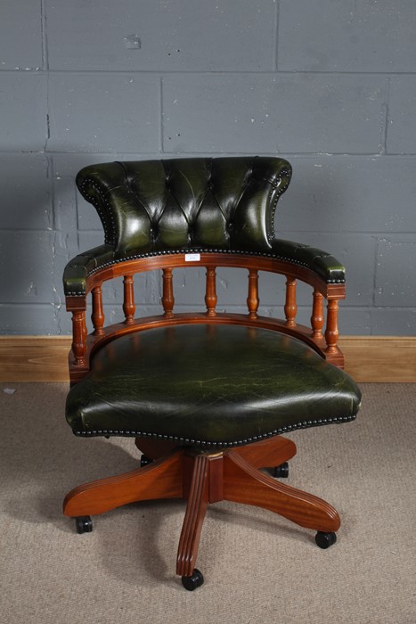 Contemporary green leather revolving desk chair, the button back above turned supports, raised on