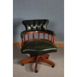 Contemporary green leather revolving desk chair, the button back above turned supports, raised on