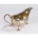 20th Century silver sauceboat, marks rubbed, maker Charles S Green & Co Ltd. with double scroll