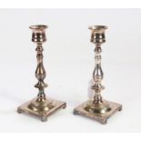 Pair of silver plated candlesticks, with baluster stems, raised on square bases, 17cm high