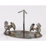 Silver plated stand, the central stem with V form terminal, flanked by two rearing lions each