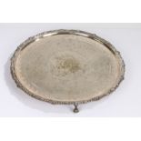 Silver plated charger, the central field with foliate and scroll decoration surrounded by a