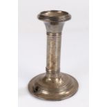 White metal reading lamp in the form of a candlestick, with reeded sconce, stem and loaded foot,