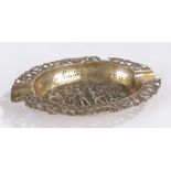 20th century Dutch silver ashtray, of oval form with pierced scroll and bird decorated border, the